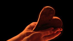 Hands holding a heart - God's grace and love.