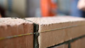 bricks and a plumb line building a legacy