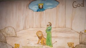 a man (Daniel) kneeling in prayer, representing his decision to purpose in his heart.