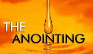 The anointing - a drop of oil on orange 