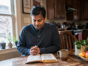 Man reading his Bible in a quiet moment of forgiveness and grace