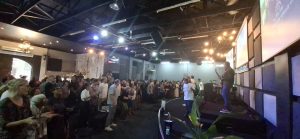 Congregation worshipping together during a Sunday service at 3C South Coast.